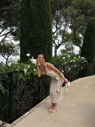 Content creator Emma Leger in a tan dress with rosette details