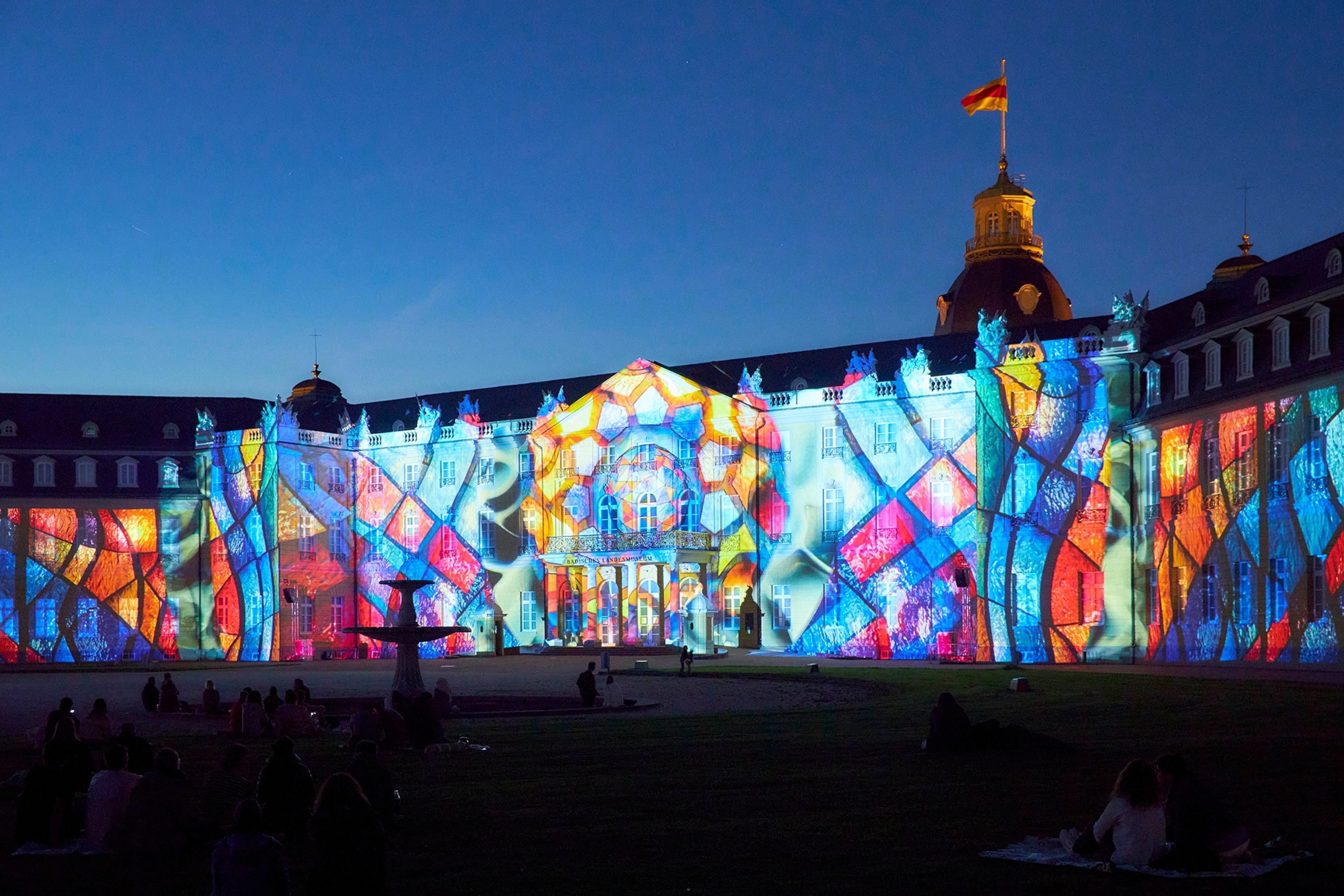 Karlsruhe Palace in the state of Baden-Württemberg, Germany, lit up with colourful lights for the Schlosslichtspiele Light Festival.