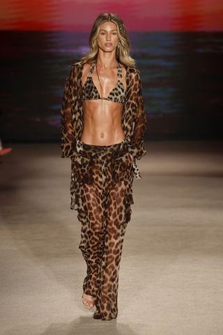 Model wears a leopard print bikini on the runway.