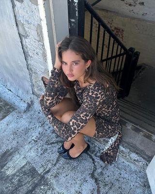 Influencer wears a leopard print dress.