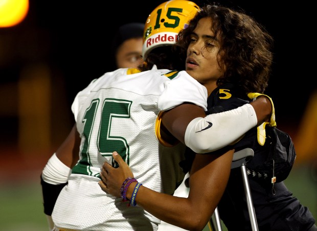 Dillon Daniels, whose mother Lucinda Daniels died tragically this week, is hugged by Live Oak's Raymond Ramirez (15) following a football game, Friday, Sept. 1, 2023, in Mountain View, Calif. (Karl Mondon/Bay Area News Group)