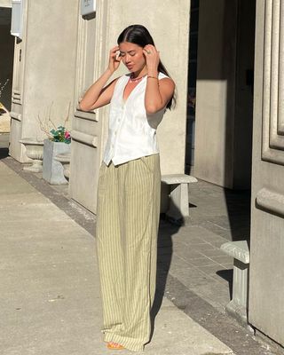 @sasha.mei wearing stripe linen trousers