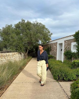 @emswells wearing yellow stripe linen trousers