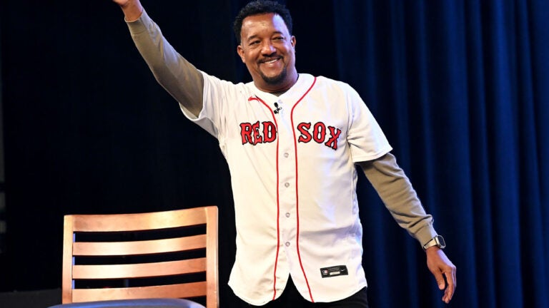 Former Red Sox pitcher Pedro Martinez waves and makes his entrance for a panel discussion on the 2004 World Series championship during the Red Sox Winter Weekend at MassMutual Center in Springfield.