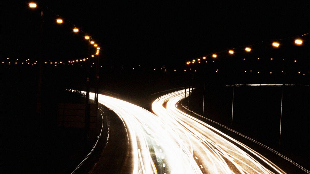 lit motorway crossroads at night