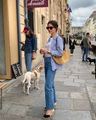 Woman in striped shirt, jeans, and espadrilles.