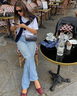 Woman in white t-shirt and jeans.