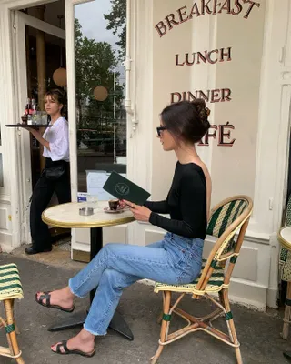 Woman in black top and slides.