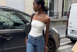 Woman in white tube top and jeans.