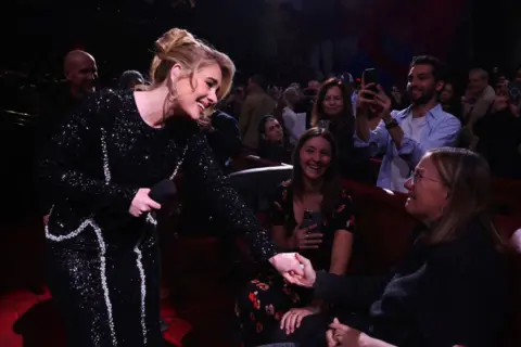 Getty Images Adele interacts with an audience member during one of her concerts in Las Vegas