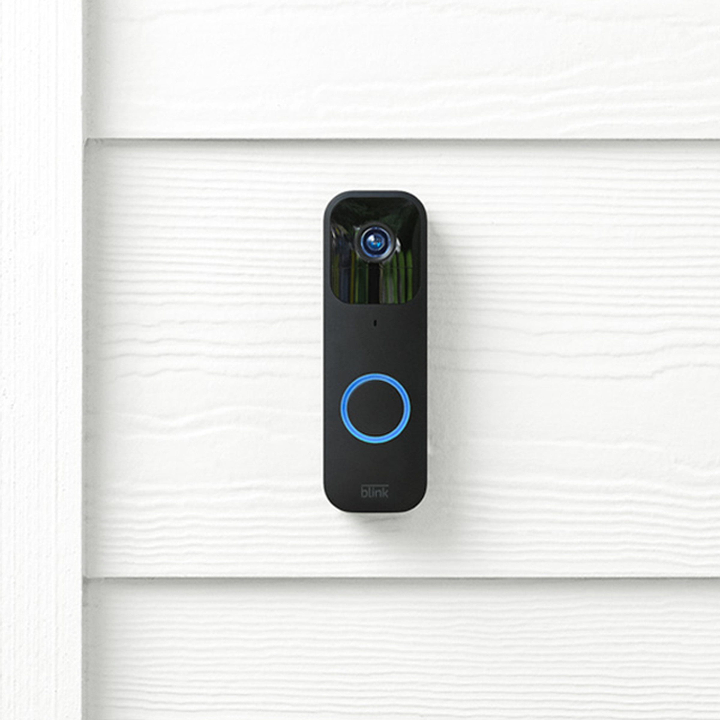 Blink video doorbell mounted on house