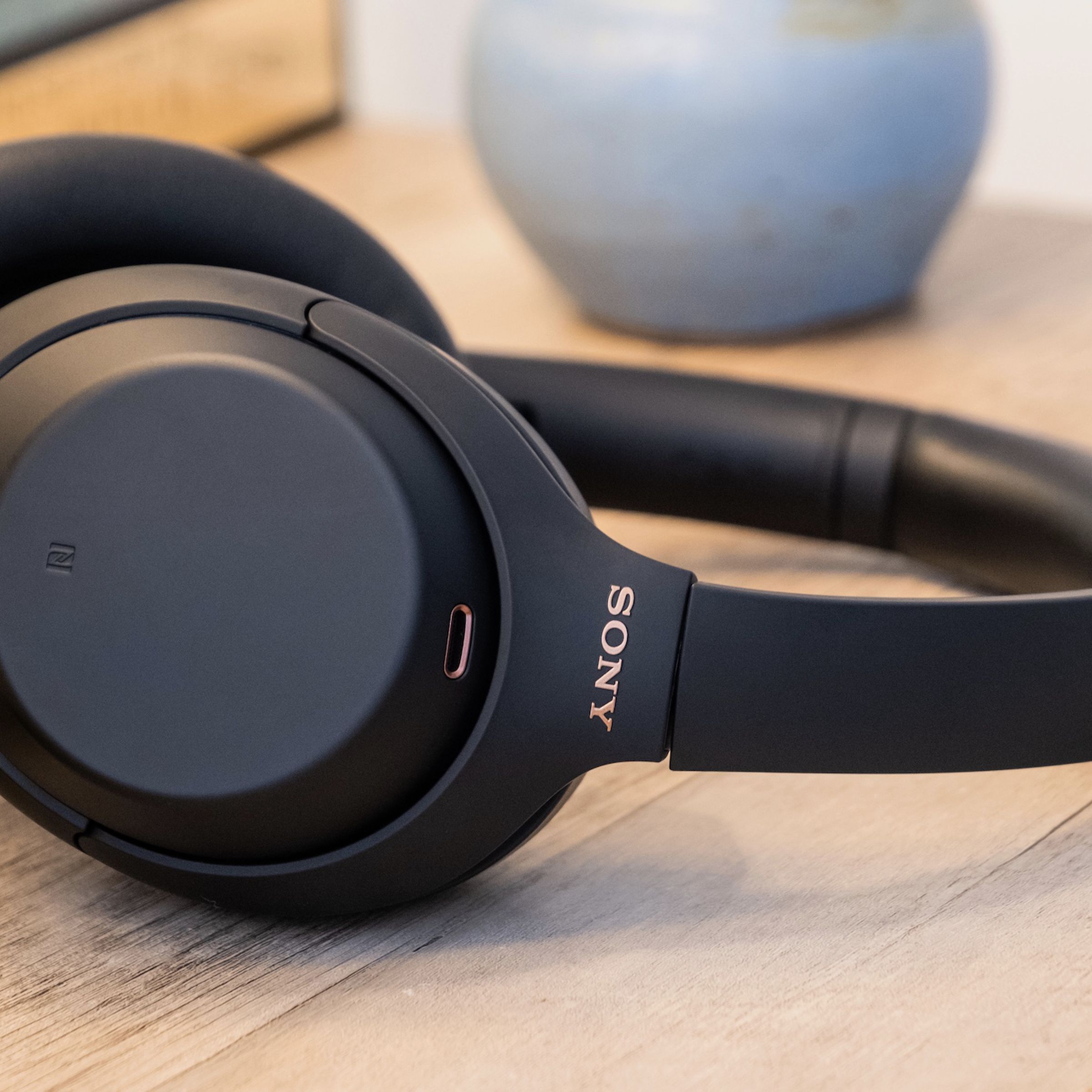 A photo of Sony’s WH-1000XM4, the best noise-canceling headphones for most people, resting on a table.