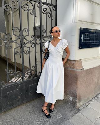 @ingridedvinsen wearing a white dress and black shoes