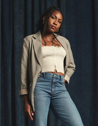 Coco Gauff wears an American Eagle Cropped Button-Up Sweater Tube Top