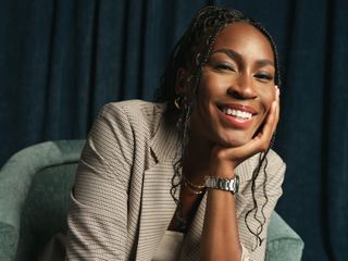 Coco Gauff smiles at the camera wearing an American Eagle blazer.