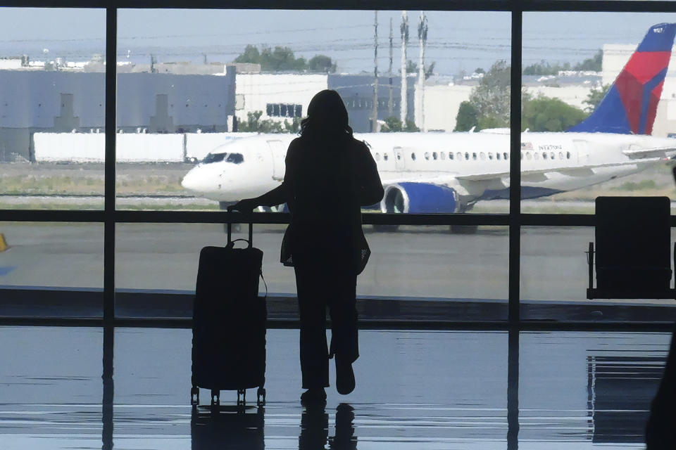 Holiday travelers pass through Salt Lake City International Airport Wednesday, July 3, 2024, in Salt Lake City. (AP Photo/Rick Bowmer)