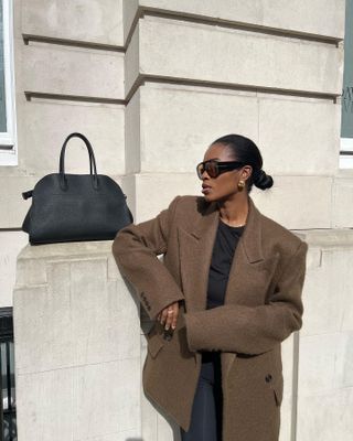 Woman in brown blazer and margaux bag