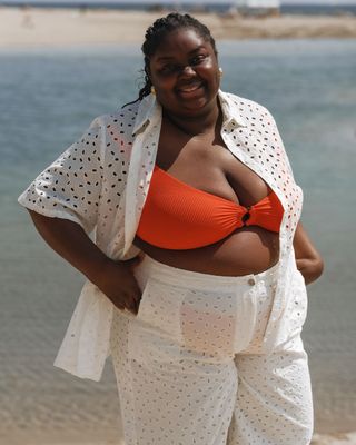 @abimarvel in an orange bikini and white set