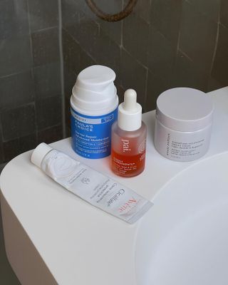 Skincare products on a bathroom counter.