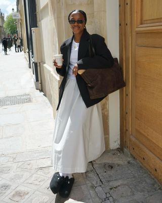 Influencer wears a brown suede bag.