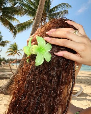 Symphani Soto styles her mermaid braids with a hibiscus claw clip