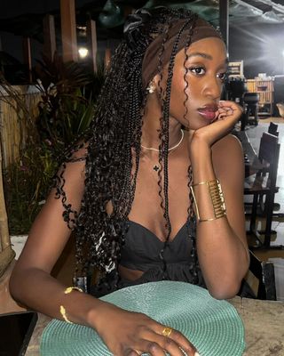 Emmanuelle Koffi wears mermaid braids on a tropical dinner date