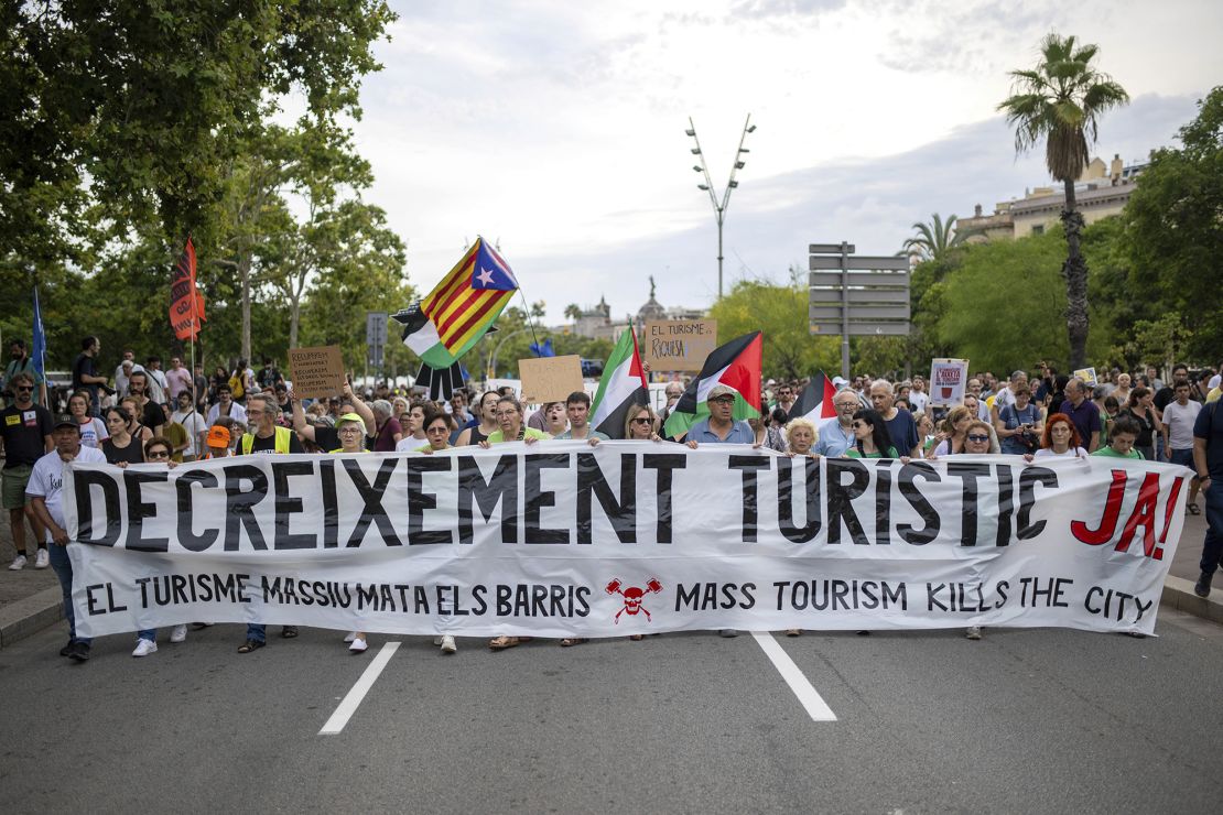 Barcelona residents held an anti-tourism march with signs in Catalan and English.