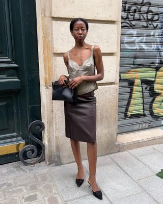 Influencer wears a brown skirt.