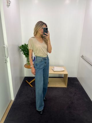 Eliza Huber wearing a sheer tan polo-neck top with jeans at the COS store.