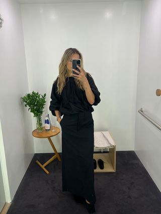 Eliza Huber wearing a black bubble blouse with a black pencil skirt at the COS store.