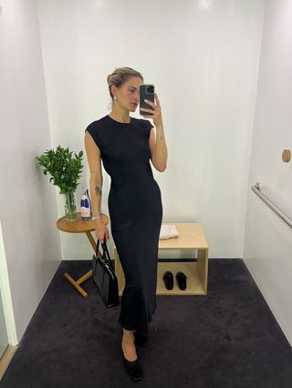 Eliza Huber wearing a navy blue satin dress at the COS store.