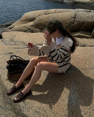 Woman wearing a striped sweater and Miu Miu boat shoes