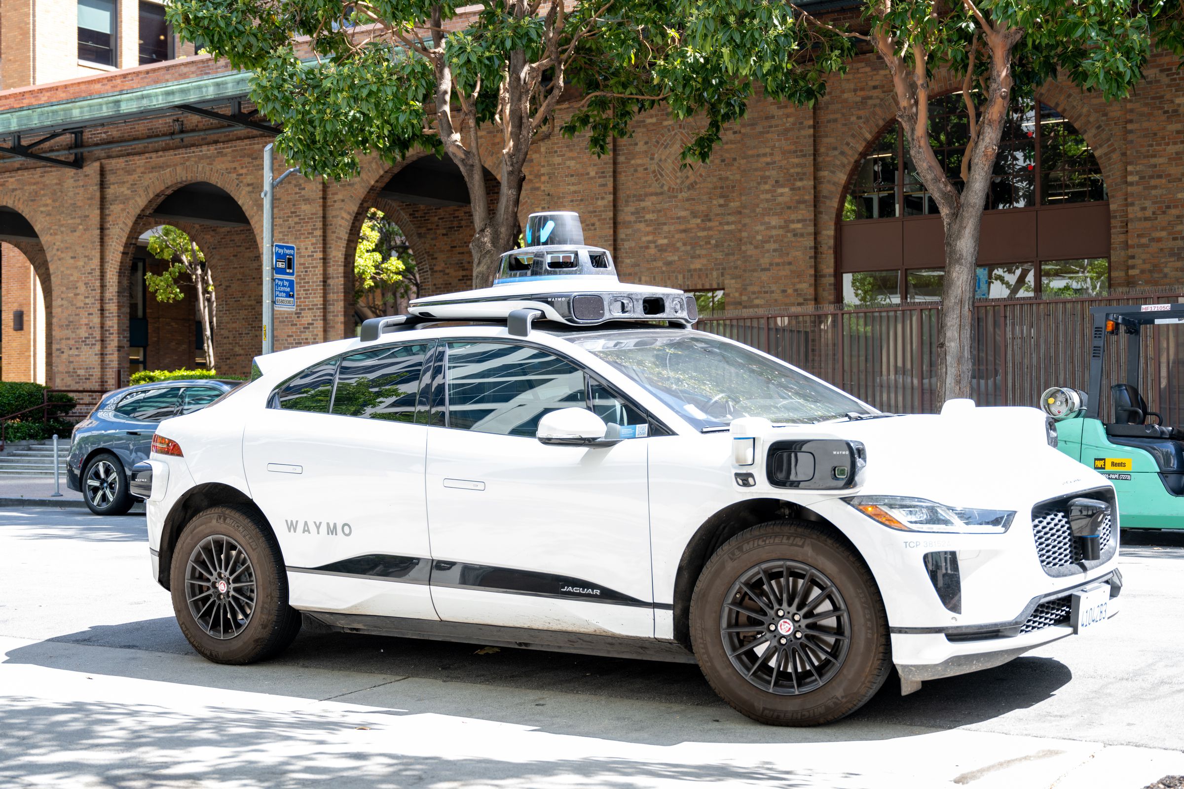 Waymo car driving on a street.