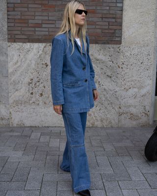 a fashion influencer wears a Canadian tuxedo denim jacket with matching jeans