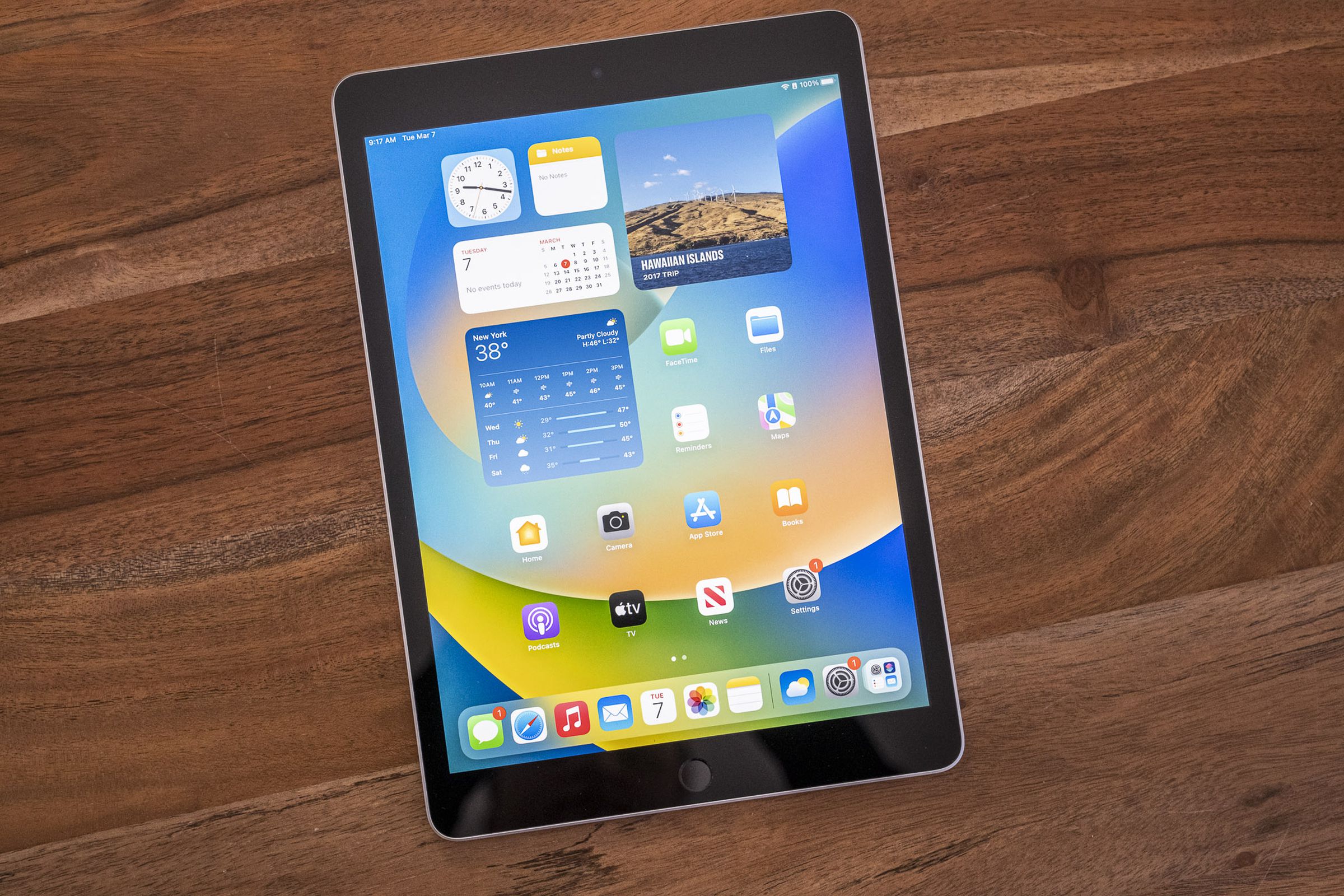 Apple’s ninth-gen iPad on a wooden table, viewed from the top down