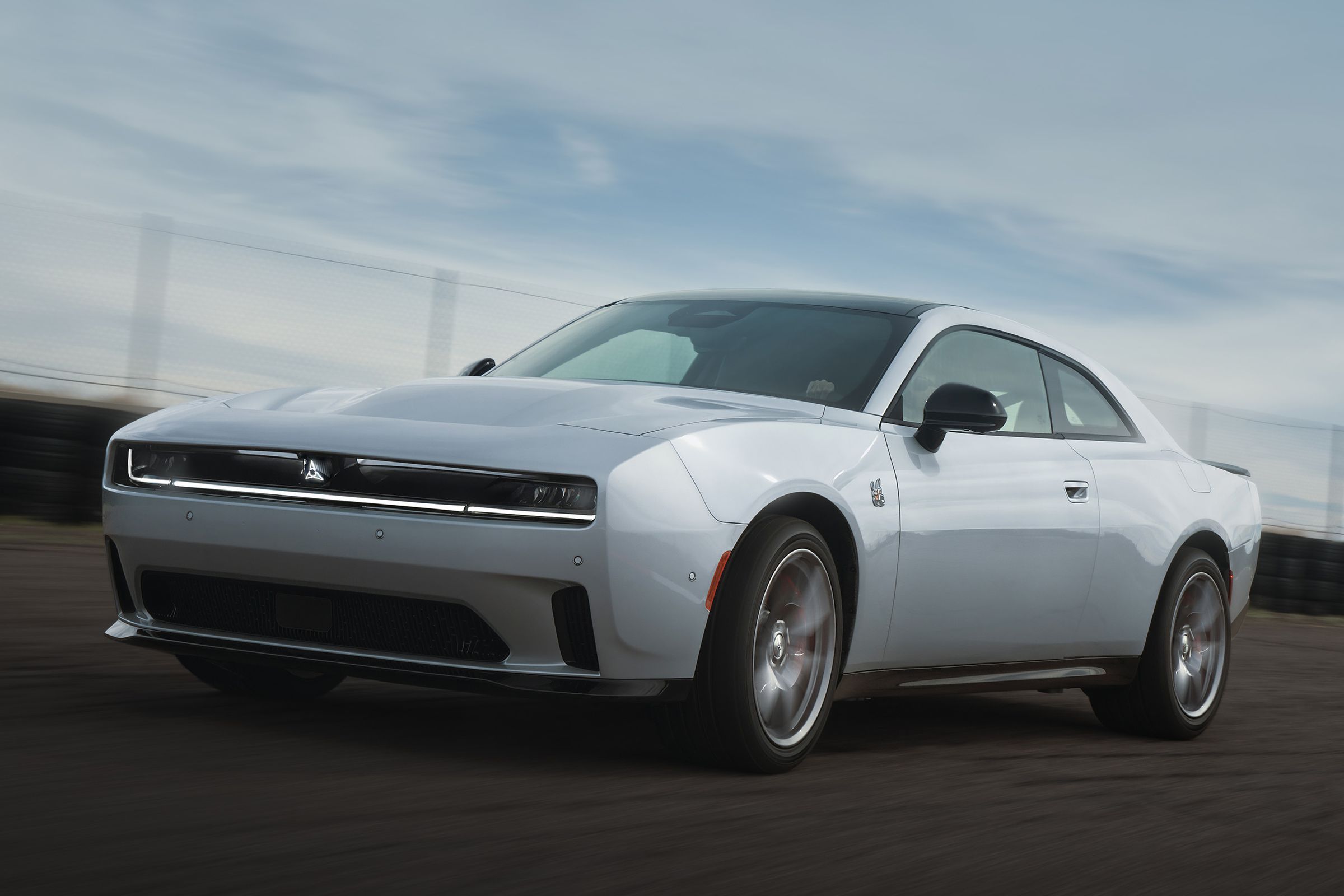 silver two-door muscle car on a track