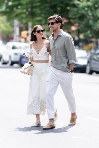 olivia palermo wearing a white crop top and skirt with johannes huebl