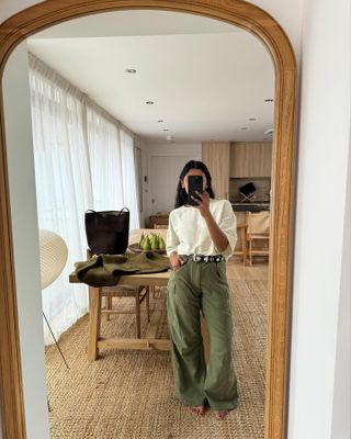 Influencer wears khaki trousers.