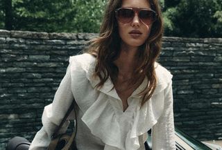 Woman in white Zara blouse.