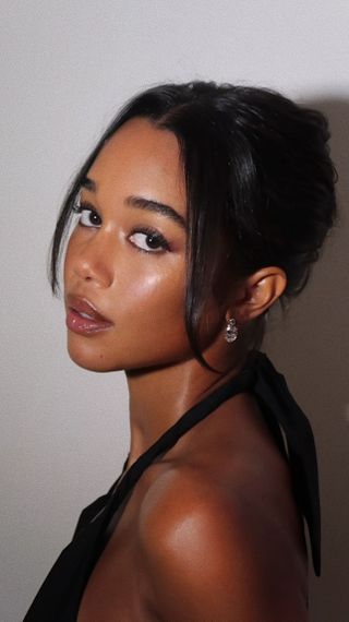 Laura Harrier with bun hairstyle with face-framing tendrils