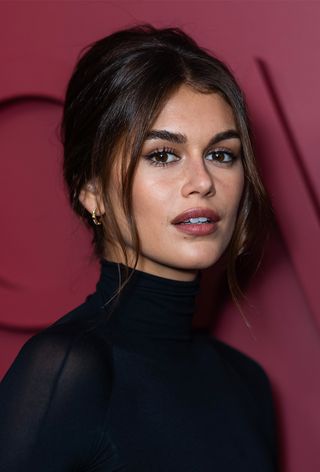 Kaia Gerber with a French twist hairstyle