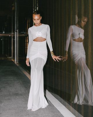 Jasmine Tookes wearing a white dress.