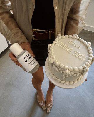 Chriselle Lim with the newest Phlur fragrance and a cake