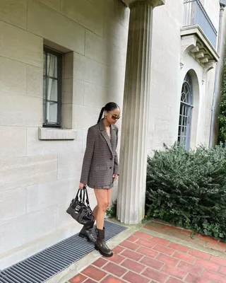 Influencer wears a skirt with biker boots.