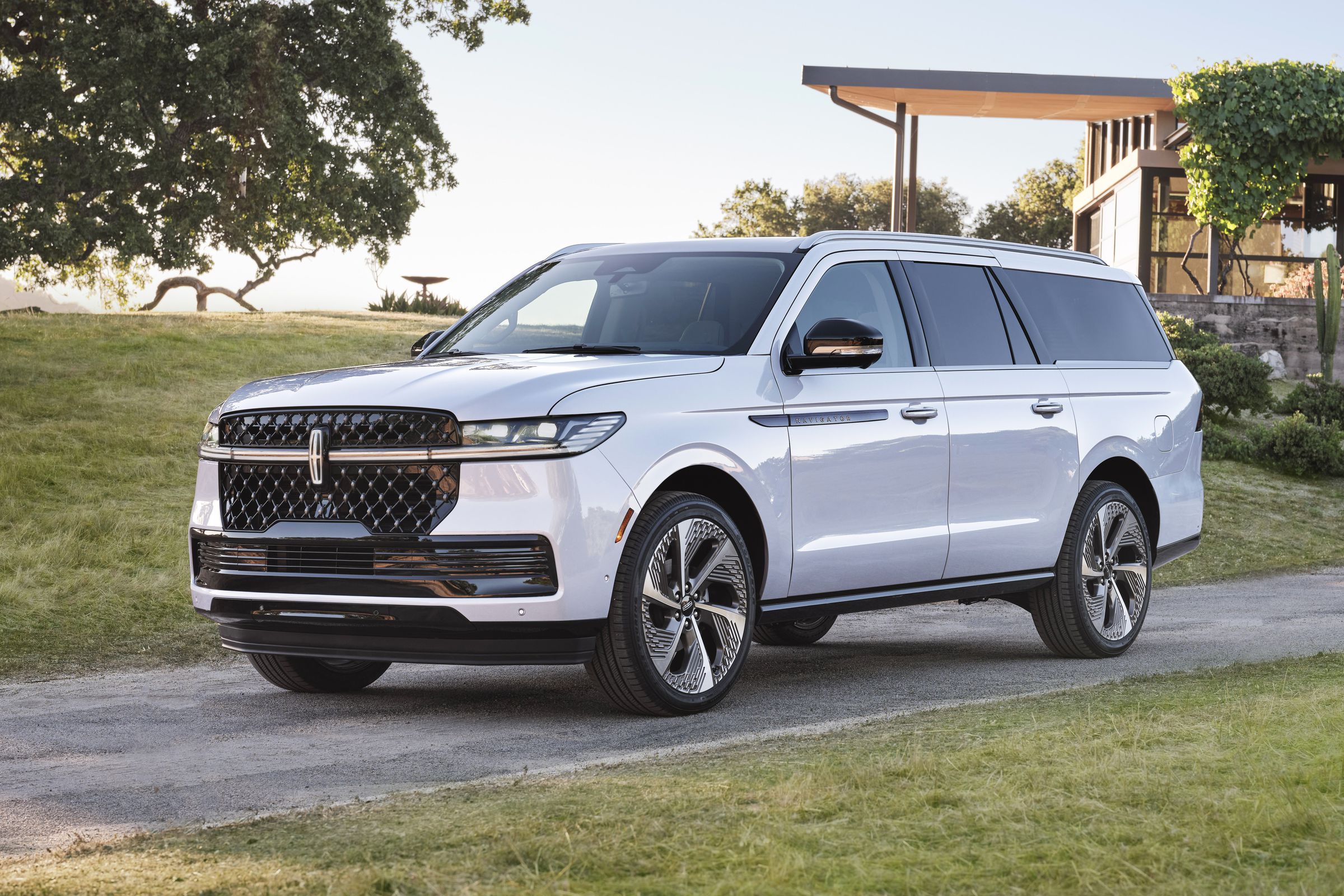 big white SUV in front of a modern building