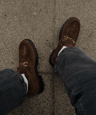 Influencer wears brown loafers.