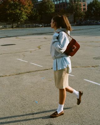 Influencer wears brown loafers.