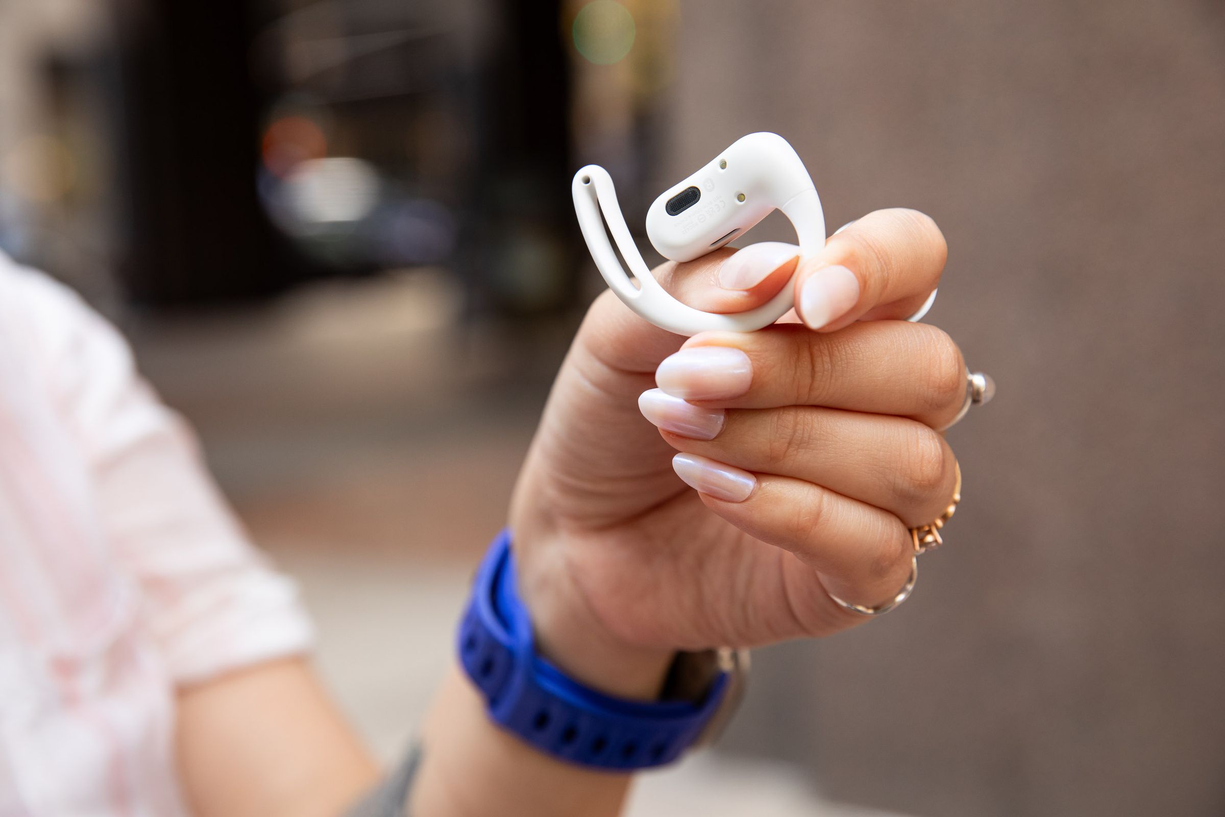 close up of someone holding the Shokz OpenFit Air