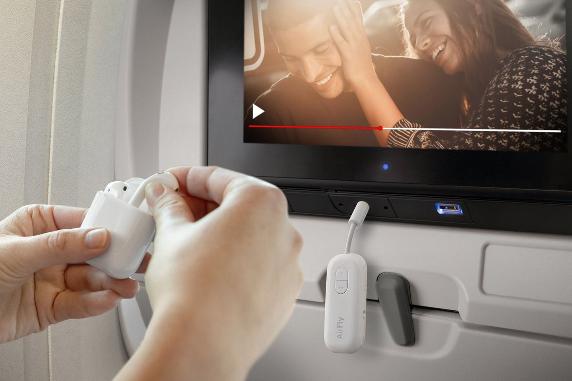 The Twelve South AirFly Duo plugged into a seatback entertainment system on a plane.