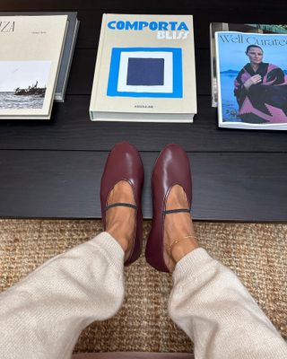 Influencer wears burgundy ballet flats.